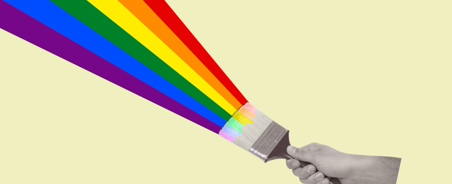 Hand dat verfbostel vastheeft waarmee die regenboog schildert